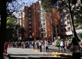 Residents in the Colombian capital of Bogotá stand outside their homes after an earthquake struck on Monday. Tremors were felt in multiple cities across the South American nation. (Ivan Valencia/AP)
