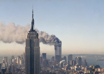 The twin towers of the World Trade Center burn behind the Empire State Building in New York, Sept. 11, 2001. In a horrific sequence of destruction, terrorists crashed two planes into the World Trade Center causing the twin 110-story towers to collapse. (AP Photo/Marty Lederhandler)