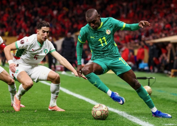 Senegal's forward #11 Nicolas Jackson and Morocco's defender #05 Nayef Aguerd fight for the ball during the Africa Cup of Nations (CAN) final football match between Senegal and Morocco at the Prince Moulay Abdellah Stadium in Rabat on January 18, 2026. (Photo by FRANCK FIFE / AFP)