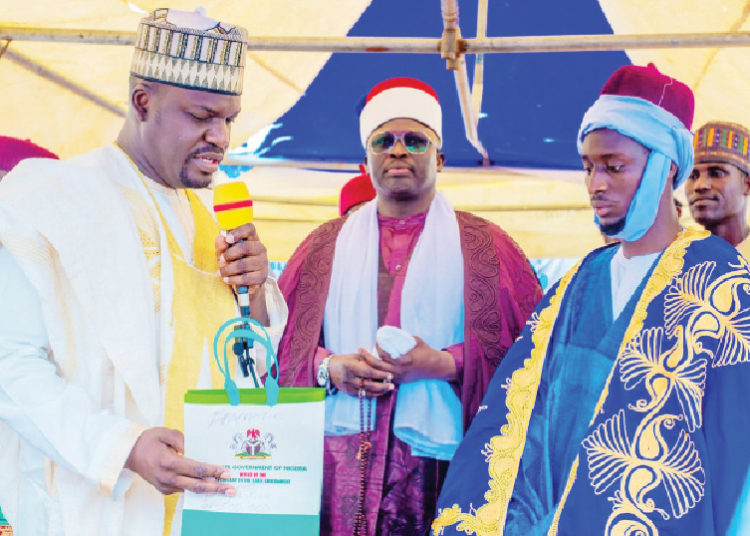 Yobe Organises 36th Qur’anic Competition, Reaffirms Commitment To Dual Education Policy 1 Yobe SSG, Dr Mohammed Goje (left), and the Emir of Damaturu, Alh. Shehu Hashimi, shortly after presenting the crown to the overall male winner of the State Qur’anic Recitation Competition, Abubakar Usman in Damaturu.