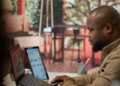 Business owner reviewing website traffic and international customer enquiries on a laptop in Lagos