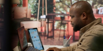 Business owner reviewing website traffic and international customer enquiries on a laptop in Lagos
